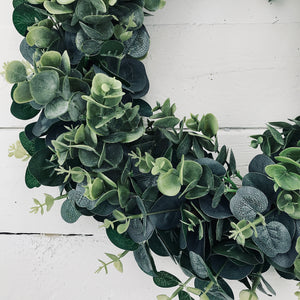 Beautifully simple and chic faux Eucalyptus Wreath in a farmhouse style completed with a rustic hessian bow. Perfect for Autumn or Winter decor. Place on your front door or hang inside your home.