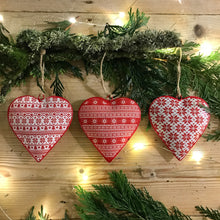 Load image into Gallery viewer, A festive themed assortment of 3 metal hanging hearts, each decorated with a traditional red and white print   Perfect for hanging around the home or on your tree at Christmas time 
